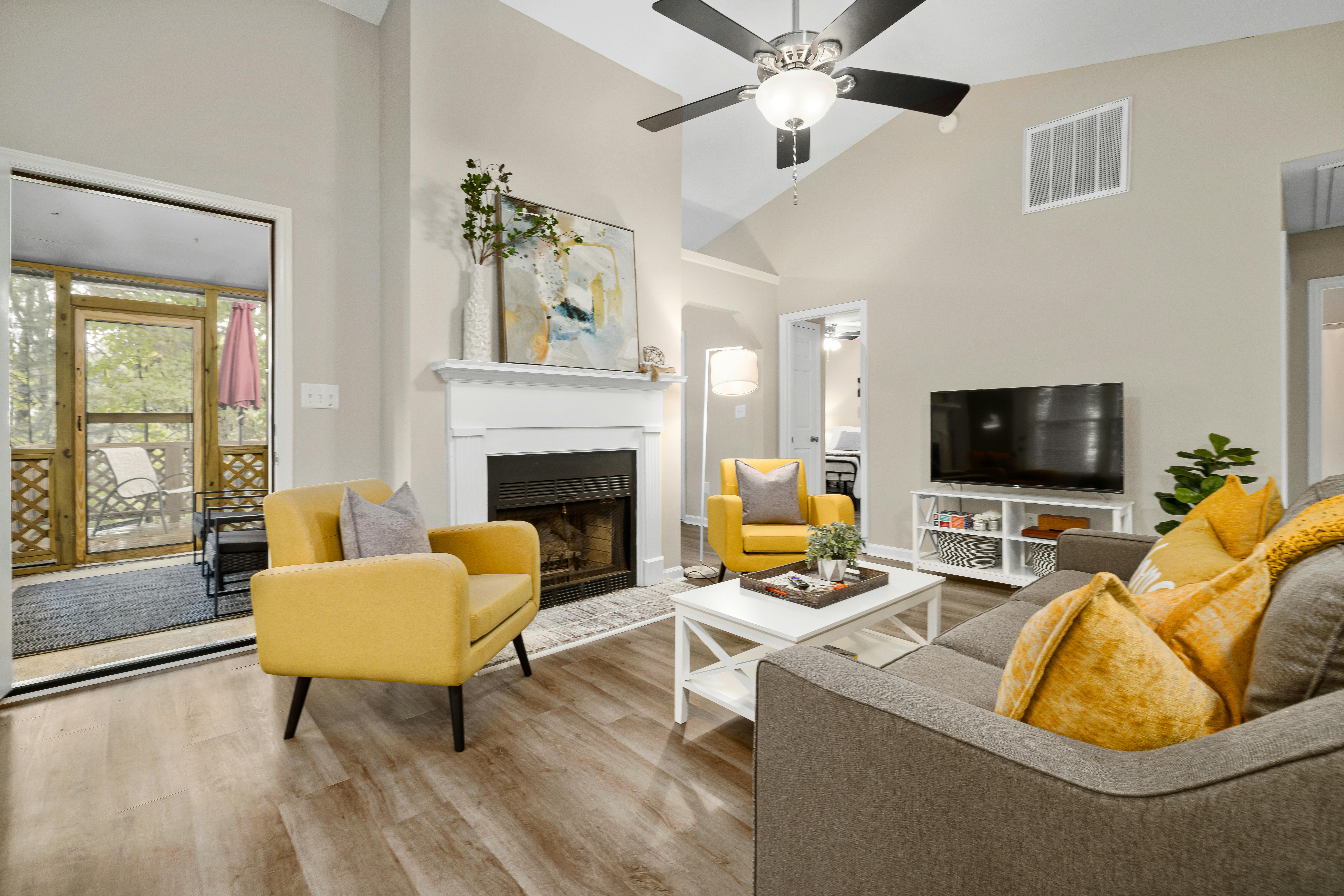 Bright modern living room interior with fireplace and natural light